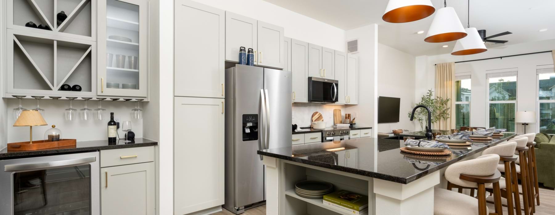 Kitchen with island, wine bar, fridge and seating